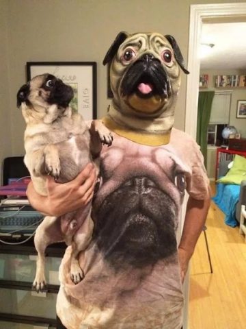 Guy with pug mask, wearing pug t-shirt and holding a pug. Wow.