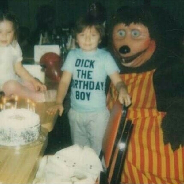 Dick the birthday boy at his birthday party next to a creepy mouse dude. Cursed image 73521.