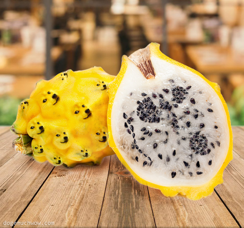 Yellow Doge Fruits laying on table, one is cut in half. It's seeds look like doge.