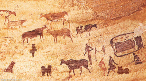 Rock art wall painting depicting the everyday life a tribe with their cows and dogs. Wow.