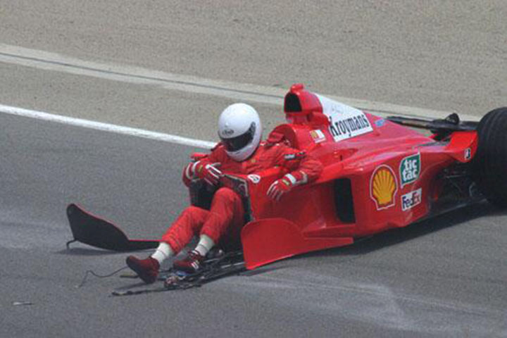 Cursed sports images: F1 car without front and driver touching track with his legs.