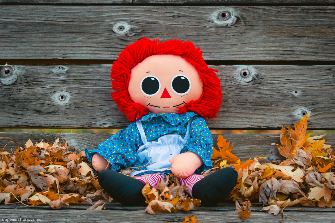 Cursed Doll Image: Red headed doll with big black eyes.