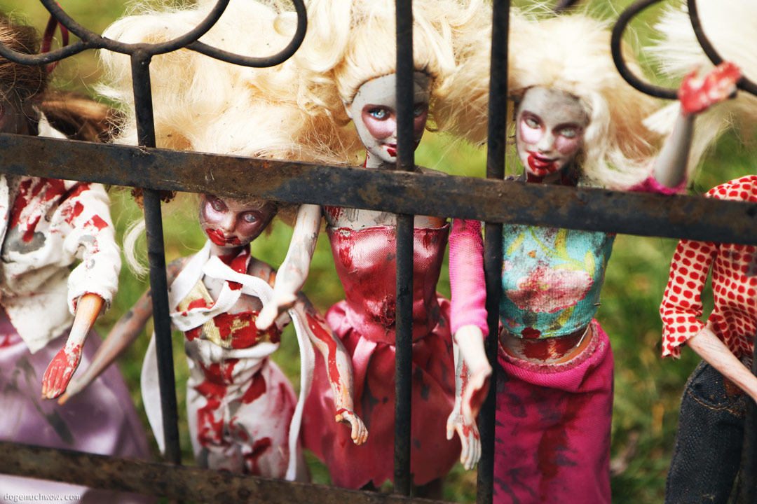 Cursed Doll Image: Zombie dolls behind fence.